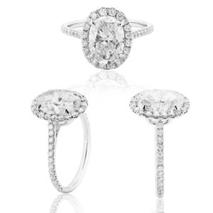Platinum and Diamond Engagement Ring with centre oval Diamond and Saw set small Diamonds in a Halo setting